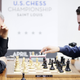 Fabiano Caruana (right) plays against legendary grandmaster Garry Kasparov (left). Photo credit: AP